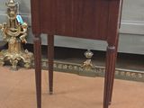 a small wooden table with a glass top on it