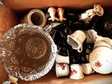 a box full of coffee cups and other items in it