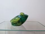 a glass table with a glass frog on it