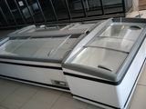 two refrigerated refrigerators sitting on the floor in a store