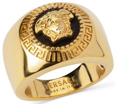 a gold ring with a lion head in the center