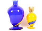 two vases sitting next to each other on a white surface
