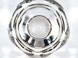 a glass object that is sitting on a white surface
