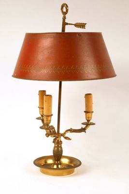 a lamp that is on a table with a red shade