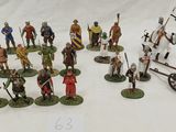 many figurines of different types and sizes on the table