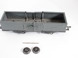 a toy train car with two wheels on a white surface