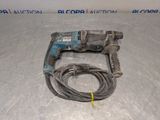 a close up of a cord and drill on a table