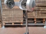 a fan that is sitting on a stand in a room