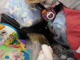 a dog that is sitting in a pile of toys