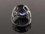 a close up of a ring with a blue stone in it