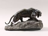 an image of a bronze statue of a lion on a rock