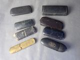many different types of pocket knives on a table
