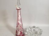 a glass vase and a glass ashtray on a white background