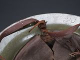 an old helmet with a leather strap on it