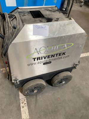 the machine is sitting on the floor in the garage