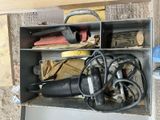 a metal box filled with assorted items on the floor