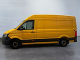 the yellow van is parked on the concrete floor in the room