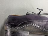 a close up of a pair of shoes hanging on a wall