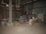a room that has a lot of boxes and pallets on the floor