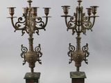 pair of antique brass candelabs on marble pedestals