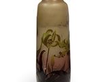 a vase with a painting on it sitting on a table