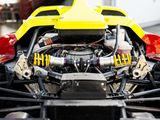 a close up of a yellow race car with its engine