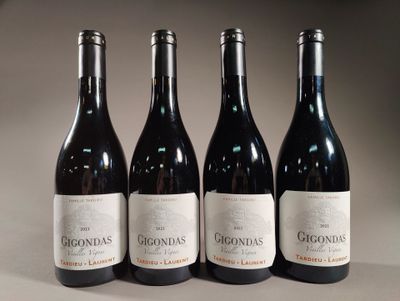 three bottles of red wine are lined up on a table