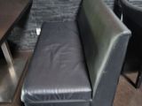 a black leather chair and a table in a room