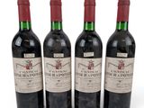 three bottles of red wine sitting next to each other on a white surface