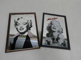 two framed photos of marilyn monroe on a wall in a room