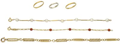 several different types of bracelets and rings on a white background