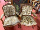 two chairs that are sitting next to each other in a room