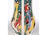 a vase with a painting on it sitting on a table
