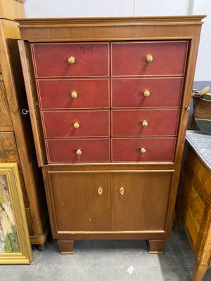 une photo d'une commode à tiroirs et d'un tableau accroché au mur