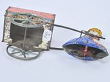 a small toy horse pulling a cart with a little girl on it