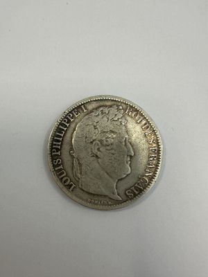 a close up of a silver coin on a white surface