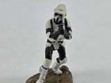 a small toy figure of a trooper standing on a rock
