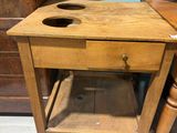 a small wooden table with a drawer underneath it