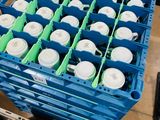 a blue crate filled with plastic cups and a blue crate filled with plastic cups