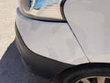 a close up of a car ' s front bumper with the door open