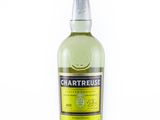 the bottle of chartreuse is sitting on a white surface