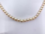 a close up of a necklace on a mannequin mannequin