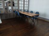 a room with a table and blue chairs in it