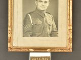 an old picture of a man in military uniform next to a badge