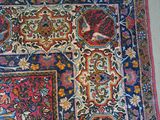 a rug on the floor with a chair next to it