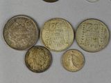 some coins are sitting on top of a table next to a coin