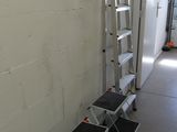 a ladder that is leaning against a wall in a room