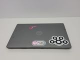 a laptop with stickers on it sitting on a table