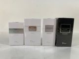 three boxes of perfume sitting on top of a white table