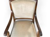 an image of a wooden chair with a beige upholstered seat